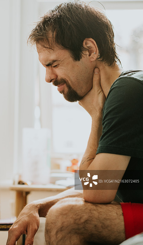 男子痛苦地捂着喉咙图片素材