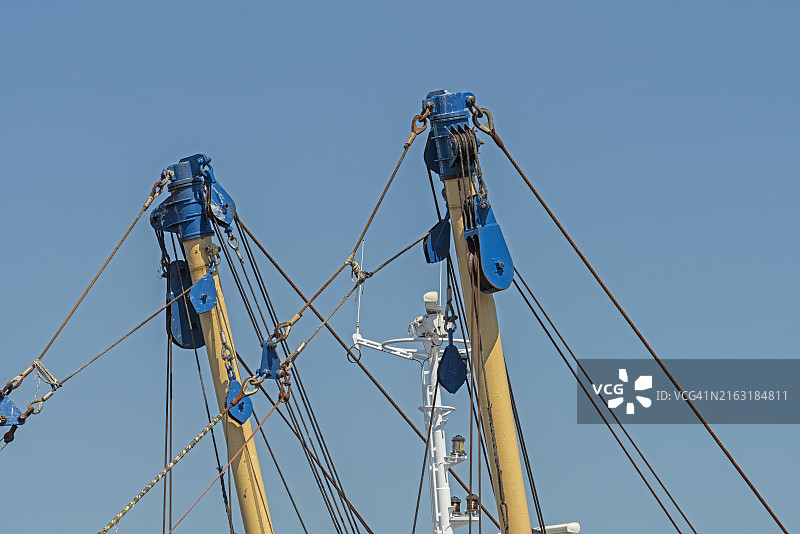 拖网渔船的吊杆和渔捞滑轮与钢缆图片素材