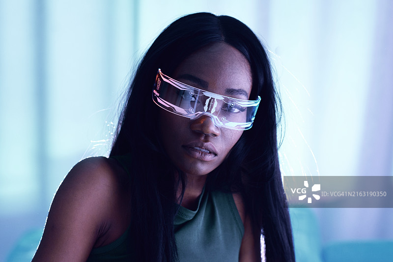 戴霓虹科技眼镜的年轻女人：未来主义和赛博朋克主题图片素材