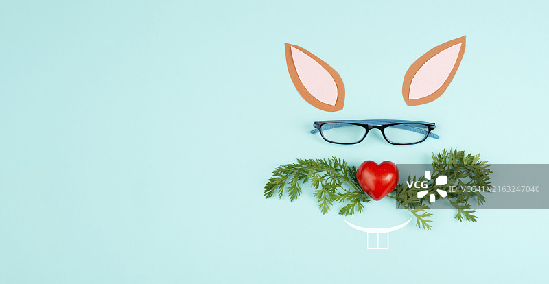 心形鼻子复活节兔子脸，胡萝卜叶须和眼镜，节日贺卡，春季图片素材