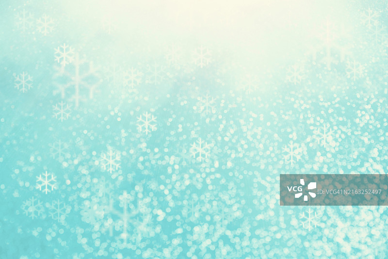 圣诞蓝色散景雪花背景，圆形灯光和阳光光束图片素材