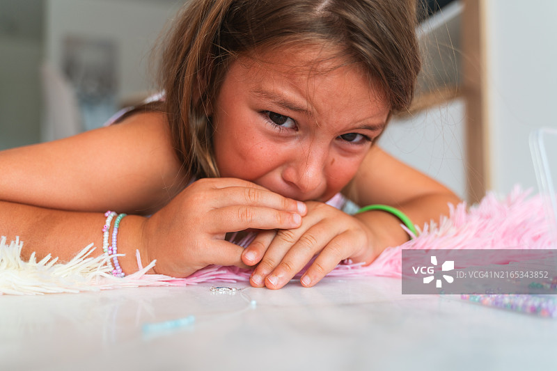 在地毯上悲伤的女孩图片素材