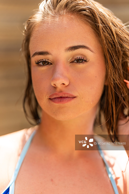 在户外摆姿势的湿发比基尼上衣年轻女人图片素材