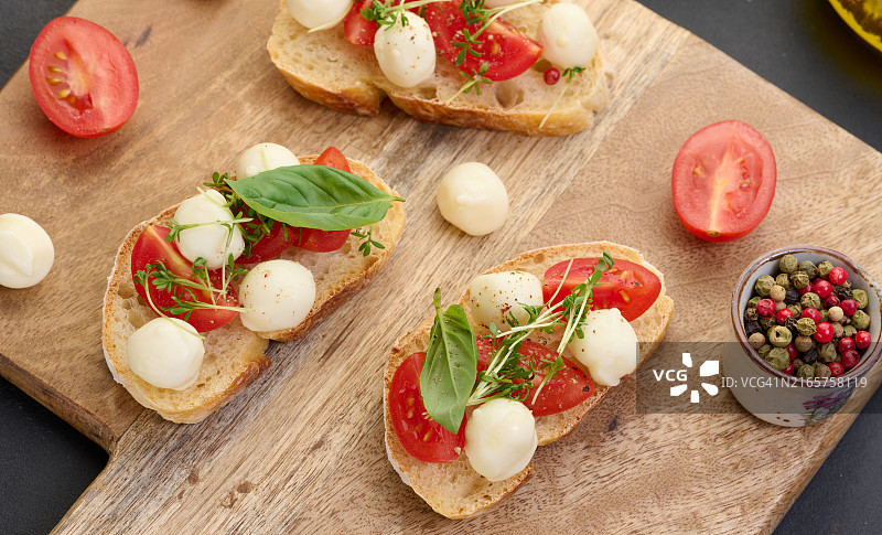 圆形马苏里拉奶酪、小番茄和细香葱放在一片白面包上，健康的三明治图片素材