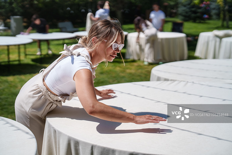 婚礼策划团队正在为婚宴铺设桌布图片素材