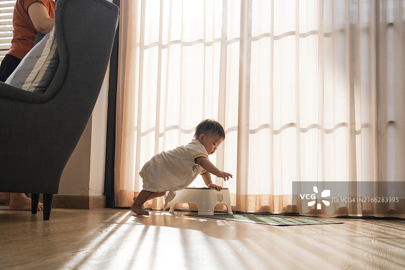 幸福的亚洲妈妈和宝宝在客厅里玩耍，享受美好时光图片素材