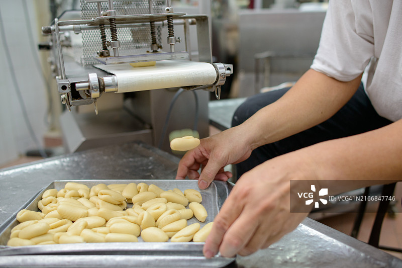 工业面包店传送带上的糕点面团图片素材