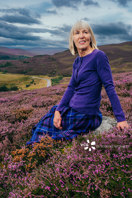 身穿传统苏格兰短裙的女人，位于苏格兰高地图片素材