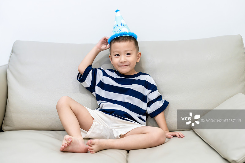 头戴生日帽的亚洲小男孩写真图片素材