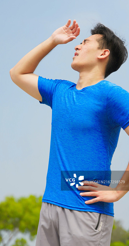 沐浴在阳光下的亚洲男人站在户外图片素材