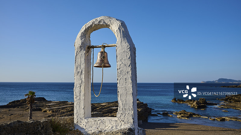 晴空下，罗德岛卡利地亚绿洲海滩阿gios Nikolaos岩石教堂的石拱门和蓝色大海图片素材