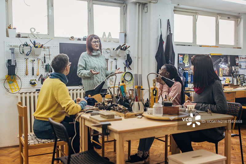 在设备完善的作坊中协同工作的团队图片素材