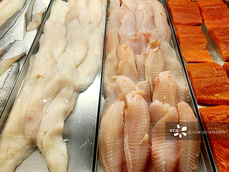 展示柜中的比目鱼、罗非鱼和鲑鱼图片素材