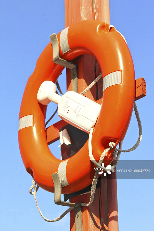 系在蓝色天空下的救生圈图片素材