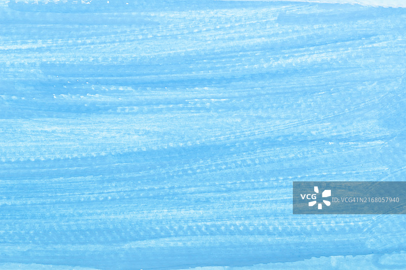 蓝色油漆纹理背景蓝色在白纸上。画笔描边。手工制作的图片素材