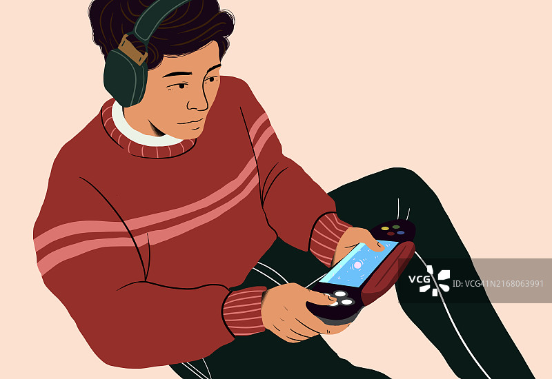 戴耳机的青少年男孩用手机和游戏手柄玩游戏图片素材