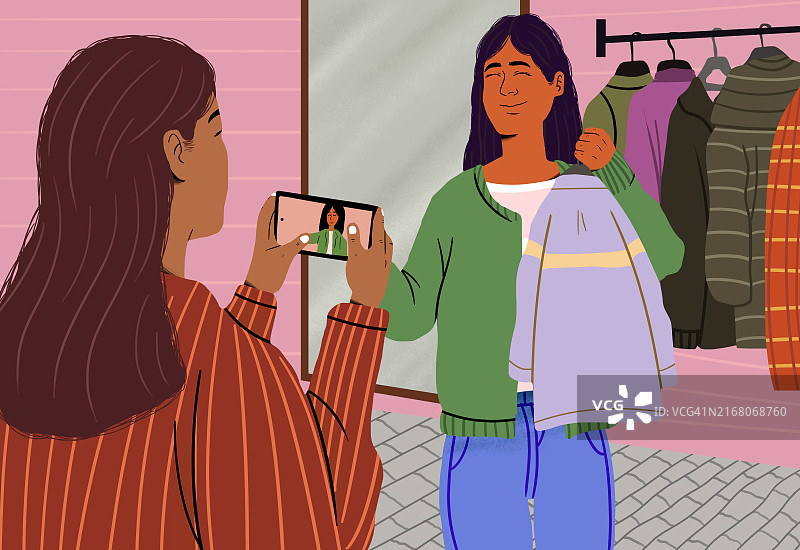 时尚网红在服装精品店通过智能手机拍摄视频博客图片素材