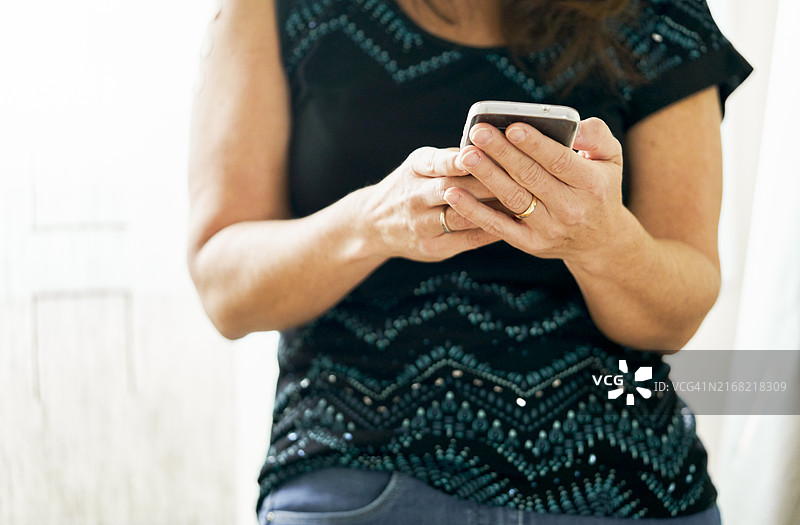 前景：优雅女性用手机打字图片素材