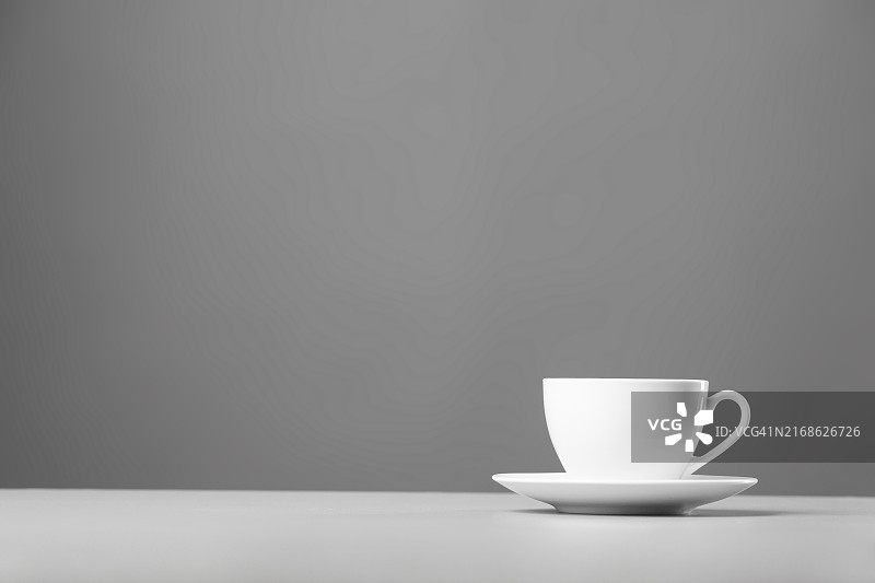 灰色背景上的白色马克杯和茶托图片素材