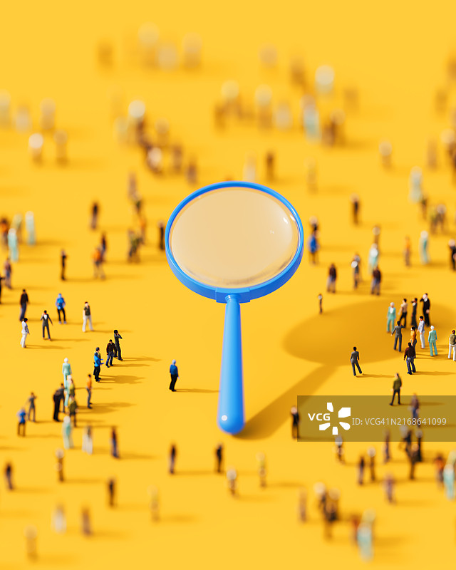 黄色背景上的人群与蓝色放大镜图片素材