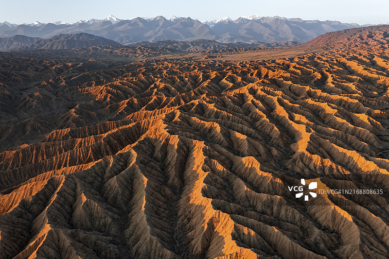 日落时分的荒地丘陵与天山山峰，亚洲吉尔吉斯斯坦伊塞克湖图片素材