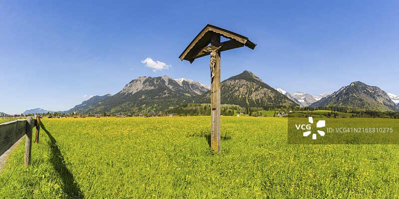 带有基督像的田野，位于德国巴伐利亚阿尔高阿尔卑斯山脉图片素材