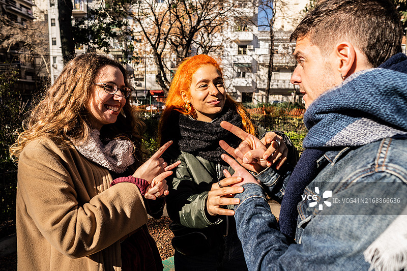 在户外用手语交流的失聪朋友图片素材