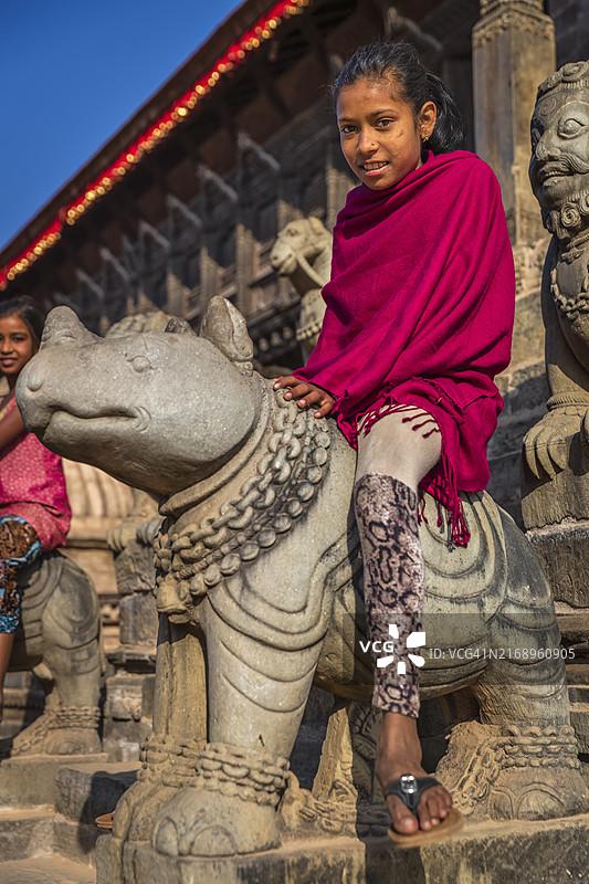 尼泊尔年轻女孩在巴克塔普尔的印度教寺庙玩耍图片素材
