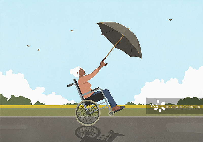 在多风的乡村，坐在轮椅上用伞当帆的年长女性图片素材