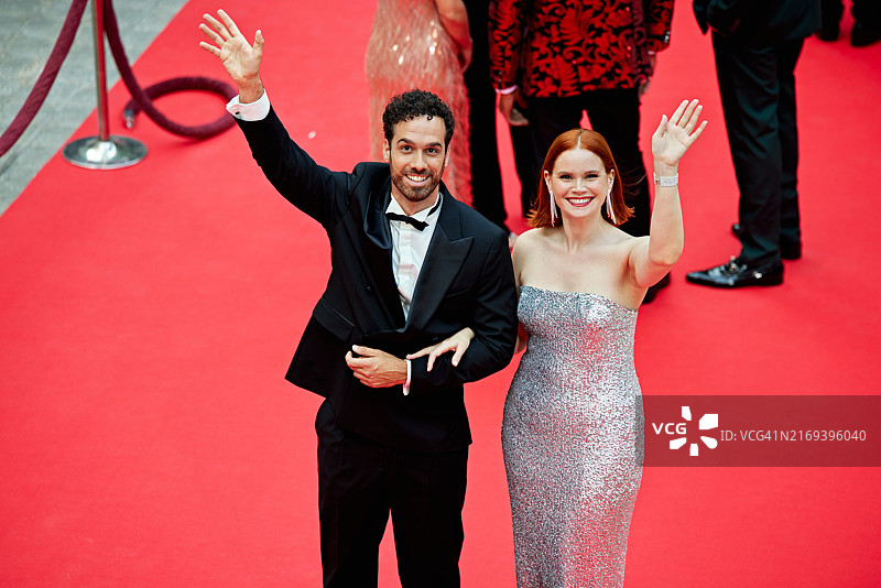 微笑的名人夫妇向相机挥手图片素材