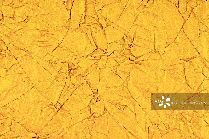 黄色皱纹纸的纹理或背景图片素材