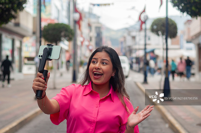 走在街上的网红，兴奋地展示城市风貌图片素材