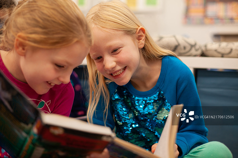 在教室图书馆一起阅读的小学生肖像图片素材