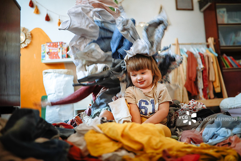 玩闹中的兄弟姐妹：扔衣服，衣柜恶作剧，欢乐时光图片素材