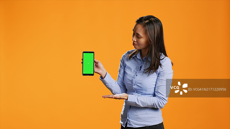 女人在手机上展示绿幕图片素材