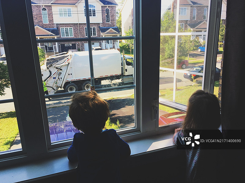 兄妹观看垃圾车图片素材