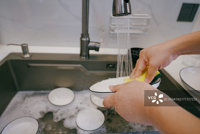 亚洲男性在洗碗，做家务图片素材