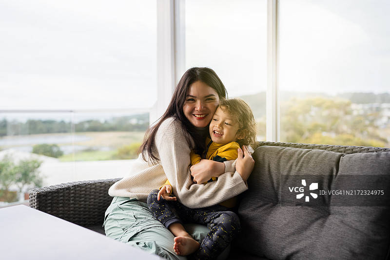 母子坐在阳台的沙发上图片素材
