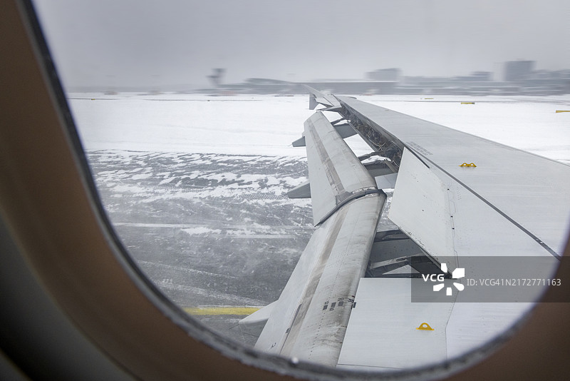 冬季冰雪跑道机场上的飞机降落图片素材