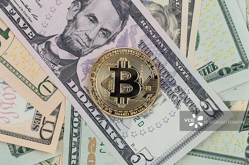 金色比特币硬币放在纸币上。虚拟加密货币。图片素材