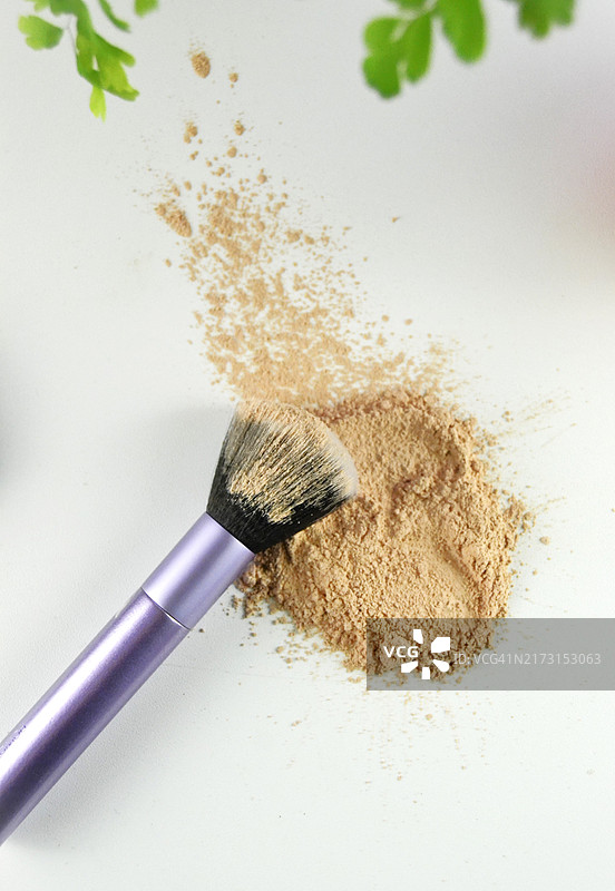 白色背景上的化妆粉和化妆刷图片素材