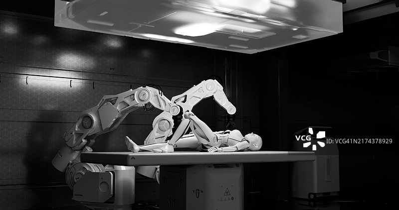 一个机器人手臂在桌子上的安卓机器人上进行操作图片素材
