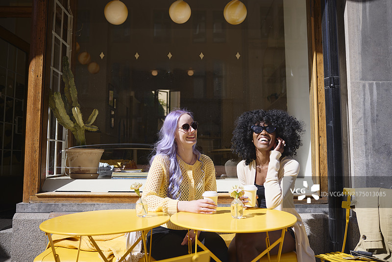 无忧无虑的年轻女子坐在桌旁图片素材