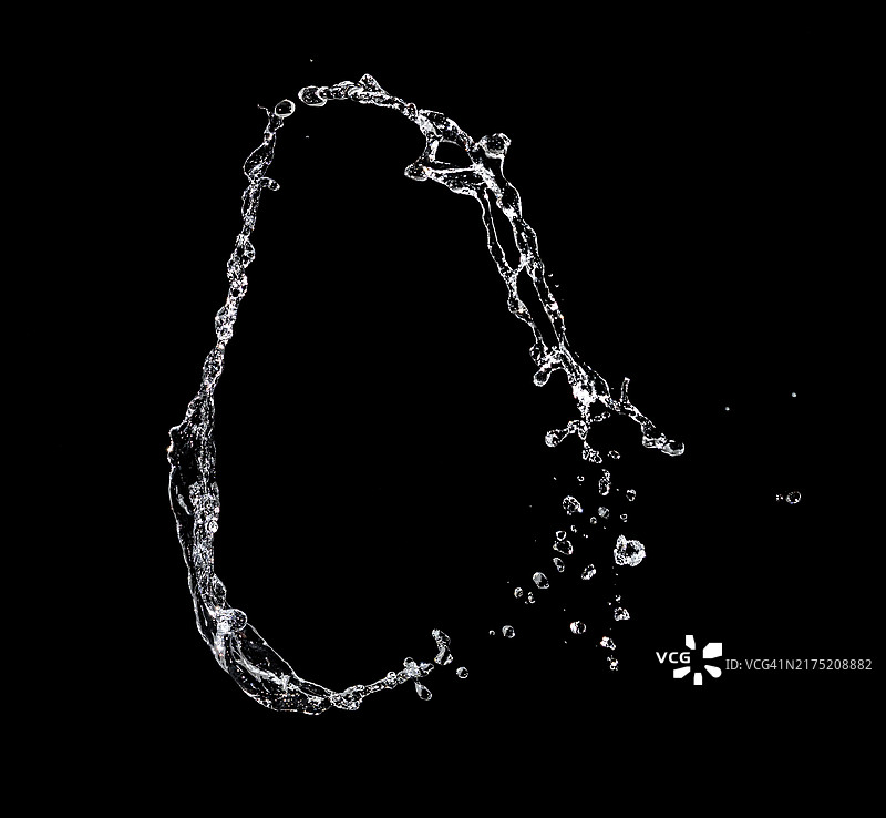 黑色背景上的圆形喷水和水花图片素材