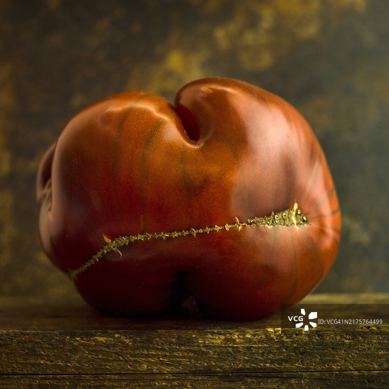 棕色背景上畸形的红色番茄图片素材