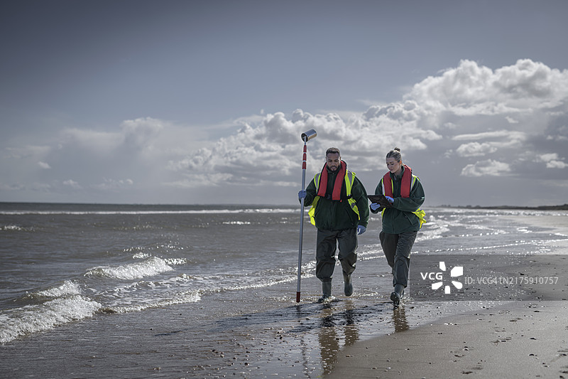 环境工作者从海中提取水样，检查污水污染、大肠杆菌和肠球菌，英格兰布里德灵顿图片素材