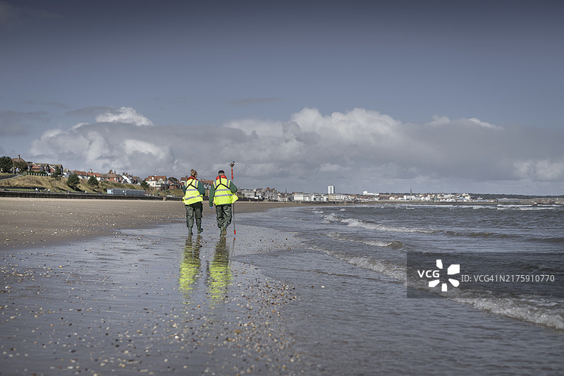 环境工作者从海中提取水样，检查污水污染、大肠杆菌和肠球菌，英格兰布里德灵顿图片素材