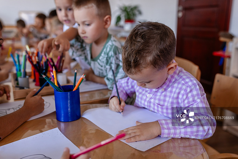 在教室里专心绘画的小孩图片素材