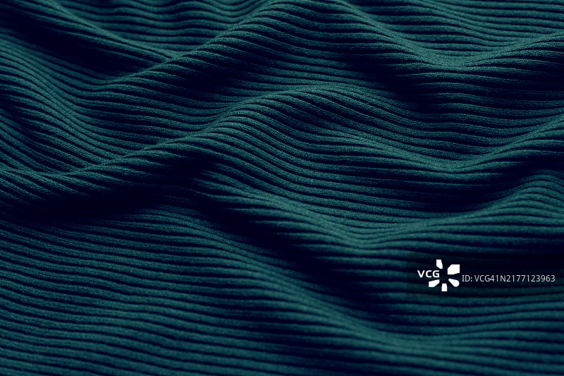 绿色毛衣的纹理波浪。图片素材