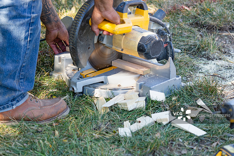 建筑工人使用电动斜切锯图片素材
